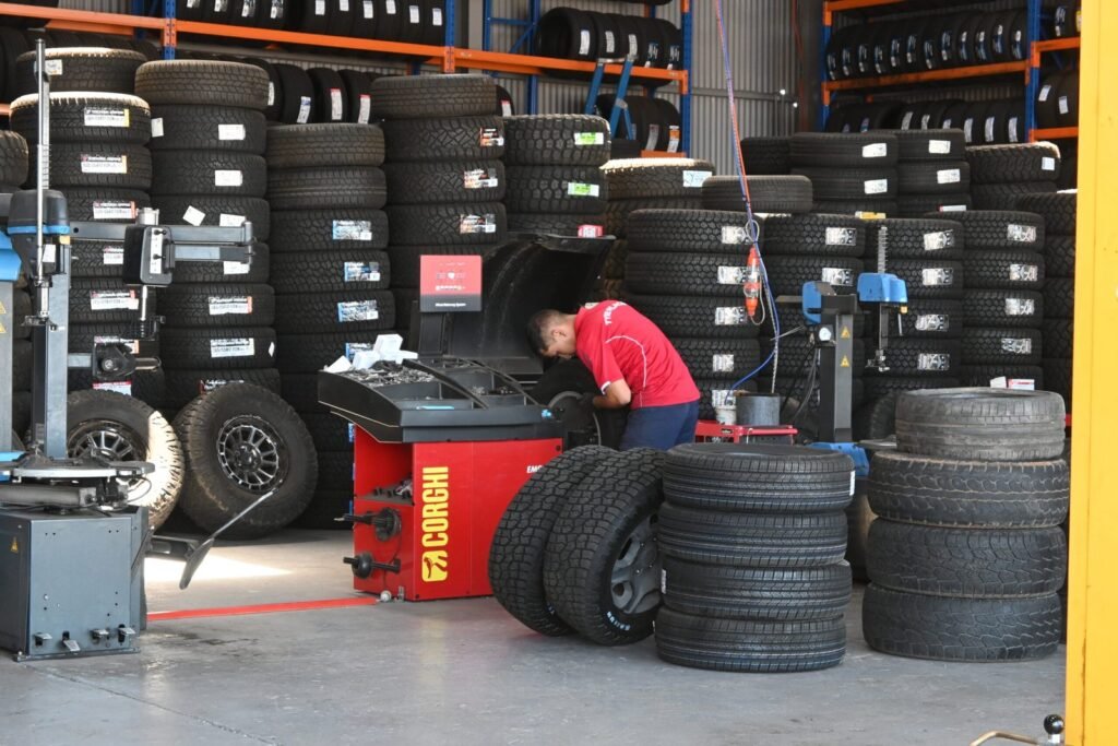 TyrePlace staff fitting a tyre in the workshop